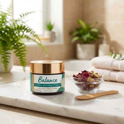 An elegant lifestyle scene featuring the 'Balance Herbal Treatment Paste' in an open, minimalist bat