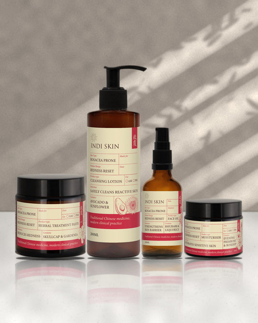 Indi Skin Redness Reset Rosacea Skinkit: herbal treatment paste, cleansing lotion, face oil and moisturiser on white marble